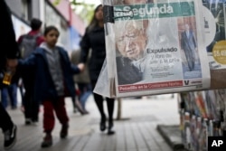 FILE - A newspaper reports on the expulsion of Fernando Karadima from the priesthood by order of Pope Francis, in Santiago, Chile, Sept. 28, 2018.