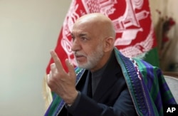 FILE - Former Afghan President Hamid Karzai speaks in Kabul, Afghanistan, April 17, 2017.