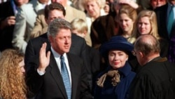 Bill Clinton takes the oath of office from Chief Justice William Rehnquist at the Capitol on January 20, 1993. Hillary Rodham Clinton and their daughter Chelsea are at his side and behind him is Vice President Al Gore.