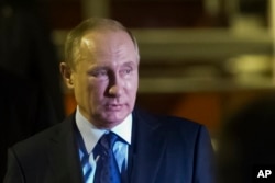 Russian President Vladimir Putin steps off a plane upon arrival for the G-20 summit in Hamburg, northern Germany, July 7, 2017.