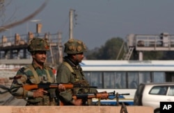 FILE - Indian army soldiers take positions outside the Indian airbase in Pathankot, 430 kilometers (267 miles) north of New Delhi, India, Jan. 2, 2016. At least four gunmen entered an Indian air force base near the border with Pakistan.