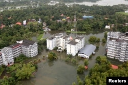 FILE - An aerial view shows partially submerged buildings at a flooded area in the southern state of Kerala, India, Aug. 19, 2018.