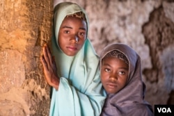 Aisha Amiru (with green hijab) said she and her younger sister look forward to getting married in a few years. (C. Oduah/VOA)
