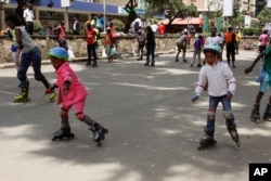 Roller skating is a fun activity to do with family and friends. In this 2015 photo, children and adults skate together in downtown Nairobi , Kenya. (AP Photo)