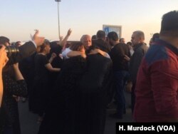 Families weep when the bodies of their loved ones are returned after dying at sea in an attempt to get to Europe. Both protesters and mourners say they are seeking better lives in Irbil, Kurdistan Region of Iraq, Sept. 29, 2017.