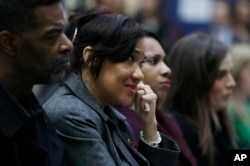 Flint Mayor Karen Weaver listens as Michigan Attorney General Bill Schuette addresses a news conference, Dec. 20, 2016 in Flint, Michigan.