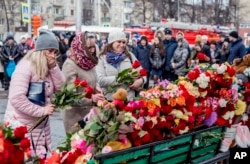 FILE - People lay flowers for the victims of a fire in a multi-story shopping center in the Siberian city of Kemerovo, about 3,000 kilometers (1,900 miles) east of Moscow, Russia.
