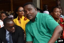 Melchiade Nzopfabarushe (R), member of Burundi's ruling National Council for the Defense of Democracy–Forces for the Defense of Democracy (CNDD-FDD) party and accused of inciting members of the ruling party to assassinate political opponents, is pictured during his trial on April 30, 2018 in Bujumbura.