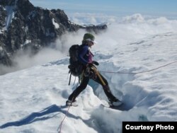 Mountaineer Stephanie Groen stands by a deep crevasse on a glacier in New Zealand, where she worries about signs of rapid ice-melt. (Courtesy: Stephanie Groen)