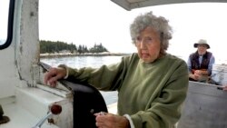 Virginia Oliver, age 101, pilots her son Max Oliver's boat, Tuesday, Aug. 31, 2021, off Rockland, Maine. (AP Photo/Robert F. Bukaty)