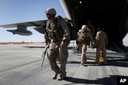 FILE - U.S. Marines are seen disembarking from a C-130 transport plane.