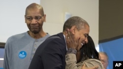 President Barack Obama is embraced by a volunteer as he visits a campaign office the morning of the 2012 election in Chicago, November 6, 2012.