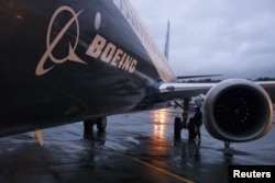 FILE - A Boeing 737 MAX sits outside the hangar during a media tour of the Boeing 737 MAX at the Boeing plant in Renton, Washington.