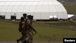 Soldiers patrol on the edge of the property of Nelson Mandela in Qunu, Eastern Cape, Dec. 12, 2013.