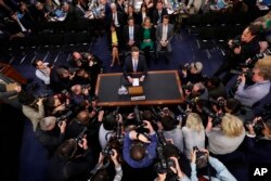 FILE - Facebook CEO Mark Zuckerberg prepares to testify before a joint hearing of the Senate Commerce and Judiciary Committees on Capitol Hill in Washington, April 10, 2018.