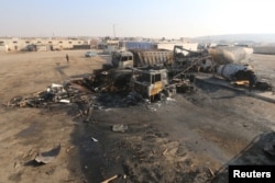 FILE - A general view shows damaged trucks after what activists said were airstrikes carried out by the Russian air force, on a parking garage for cargo trucks in al-Dana town, near the Syrian-Turkish border in Idlib Governorate, Nov. 28, 2015.