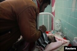 Saleh al-Faqeh covers the body of his daughter, Hajar, who died at the malnutrition ward of al-Sabeen hospital in Sanaa, Yemen, Nov. 15, 2018.