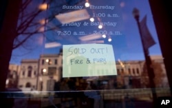 Sign posted at the door for Kramerbooks & Afterwords Cafe indicating that the book "Fire and Fury: Inside the Trump White House" is sold out at the bookstore located in the Dupont Circle neighborhood in Washington, Friday, Jan. 5, 2018. (AP Photo/Pablo Ma
