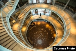 A student walks down the main stairway in the Lillis Business Complex at the University of Oregon.