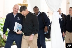 Air Force Gen. Carlton D. Everhart II, left, speaks to Navy Adm. Bill Moran, Vice Chief of Naval Operations, second from left, while arriving with other generals and admirals for a meeting with Donald Trump at Mar-a-Lago, in Palm Beach, Fla., Wednesday, Dec. 21, 2016. (AP Photo/Andrew Harnik)
