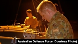 A RAAF Aircraft Armament Technician installs the laser guided system to a bomb in the Middle East Region.