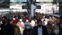 People walk along a platform after departing from a train at King's Cross Station, amid the COVID-19 outbreak in London, Britain, October 21, 2021.