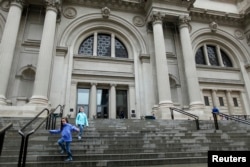 FILE - Children run down the stairs of The Metropolitan Museum of Art in New York, Oct. 2012.