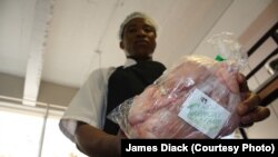 A cook, Nhlanhla Khumalo, prepares to roast a New Harmony chicken inside the kitchen of The Service Station restaurant in Johannesburg