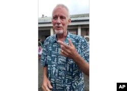 In this image made from video, Bill Jaynes, managing editor of the Kaselehlie Press in FSM, or Micronesia, explains his experience as a passenger on a plane that crashed in the waters off Chuuk Island, in the Federated States of Micronesia, Sept. 28, 2018