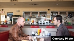 Bruce Willis and Joseph Gordon-Levitt as "Joe" in TriStar Pictures, Film District, and End Game Entertainment's action thriller LOOPER.