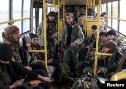 Turkish-backed Free Syrian Army fighters are seen on a bus in the town of al-Rai, Syria, Feb. 14, 2018.
