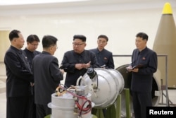 FILE - North Korean leader Kim Jong Un, center, provides guidance on a nuclear weapons development in this undated photo released by North Korea's Korean Central News Agency in Pyongyang, Sept. 3, 2017.