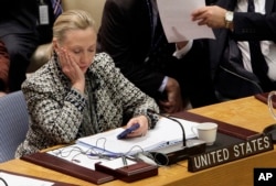 Campaign 2016 Clinton Emails: FILE - In this March 12, 2012, file photo, then-Secretary of State Hillary Clinton checks her mobile phone after her address to the Security Council at United Nations headquarters. In a rare step, the FBI on Friday, Sept. 2, 2016, published scores of pages about confidential interviews with Hillary Clinton and others from its recently closed investigation into the former secretary of state’s use of a private email server.