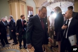 Senate Minority Leader Charles Schumer returns to the Senate chamber Tuesday after answering reporters' questions about President Trump.