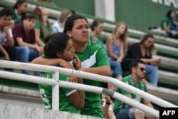 People pay tribute to the players of Brazilian team Chapecoense Real who were killed in a plane accident in the Colombian mountains, at the club's Arena Conda stadium in Chapeco, in the southern Brazilian state of Santa Catarina, Nov. 29, 2016.