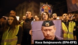 SERBIA -- People wave Serbian national flags, carry banners with anti-NATO slogans, outside the General Staff building. March 24, 2019