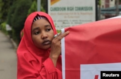 FILE - Security and women's empowerment are summit themes. A demonstrator at an October "#Bring Back Our Girls" rally calls for the release of girls abducted by Boko Haram militants, outside the Cameroon Embassy in Abuja.