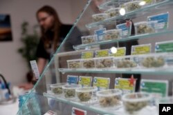 In this Dec. 29, 2017, photo, various kinds of marijuana strains are displayed at the KindPeoples dispensary in Santa Cruz, Calif.