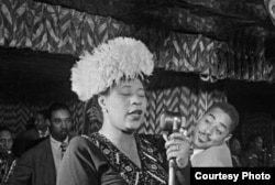 Ella Fitzgerald sings at the Downbeat Club in New York, with Dizzy Gillespie listening, at right in the background, 1947. (William Gottlieb/Library of Congress)