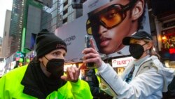 A woman shows proof of vaccination against COVID-19 to enter Times Square for the New Year's Eve ball drop in New York, Dec. 31, 2021.