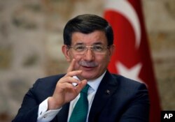 FILE - Turkish Prime Minister Ahmet Davutoglu speaks to a group of foreign reporters in Istanbul, Turkey, Dec. 9, 2015.