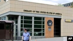 In this file photo, a Russian policeman stands in front of an entrance to the U.S. Embassy in downtown Moscow, Russia, on May 14, 2013.