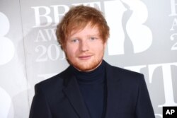 Ed Sheeran poses for photographers upon arrival at the Brit Awards 2017 in London, Feb. 22, 2017.