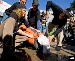 FILE - Protesters simulate the use of waterboarding on a volunteer at an anti-torture rally in front of the Justice Department in Washington, Nov. 5, 2007.