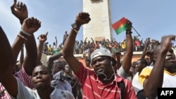 People celebrate in the capital Ouagadougou after Burkina Faso's embattled President Blaise Compaore announced he was stepping down, Oct. 31, 2014.