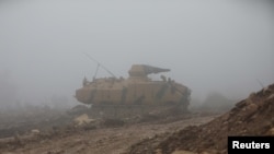 A Turkish military tank is seen near Mount Barsaya, northeast of Afrin, Syria, Jan. 23, 2018. Five Turkish soldiers died Saturday in the Afrin area when their tank was attacked.