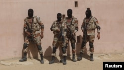 FILE - Pakistan Rangers prepare to take their positions during a counterterrorism training demonstration at the Rangers Shooting & Saddle Club on the outskirts of Karachi, Pakistan, Feb. 24, 2015.