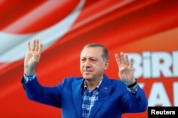 FILE - Turkey's President Tayyip Erdogan greets people at the United Solidarity and Brotherhood rally in Gaziantep, Turkey, Aug. 28, 2016.