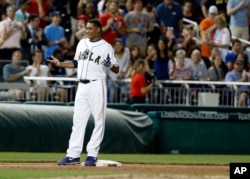 Congressman Cedric Richmond stands on third base after his triple in Congressional baseball game.