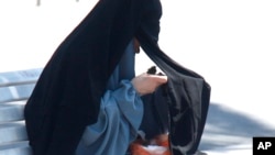 Seorang perempuan berniqab sedang makan di Prancis.